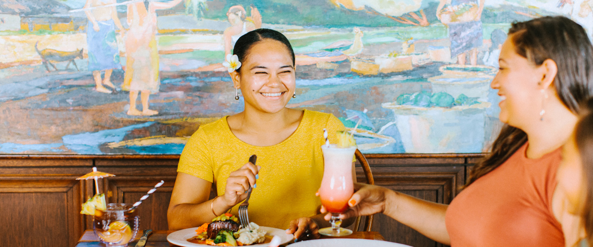 Two friends enjoying their meals and drinks