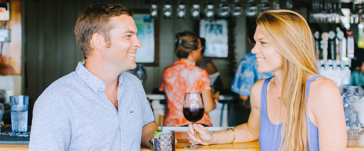 A happy couple enjoying a beverage at the bar