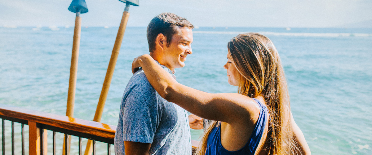 A happy couple on the outside deck enjoying the view off the coast of maui