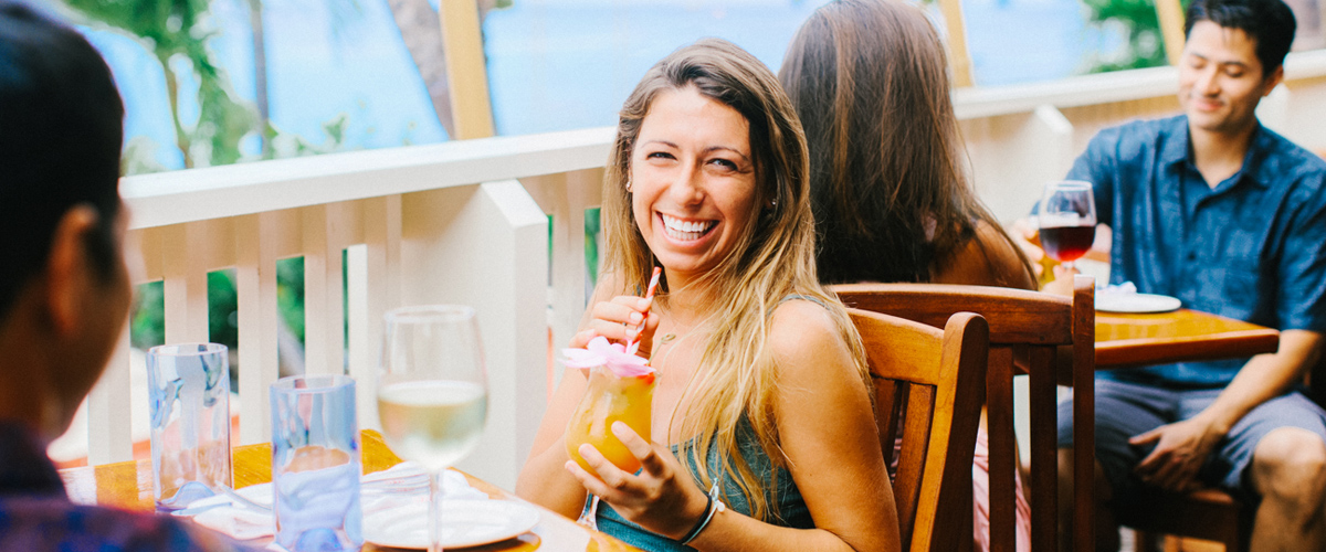 A happy customer enjoying the view and her drink